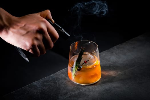 aromatic cocktail with a sprig of pine needles and round ice