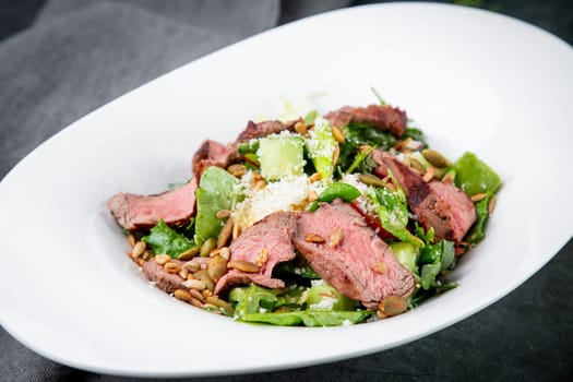 salad with pieces of beef, pistachios, lettuce and cheese. High quality photo