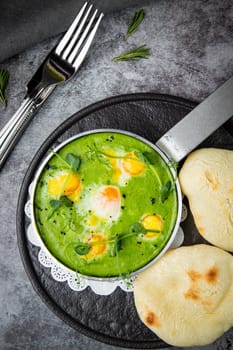 green broccoli soup with egg and herbs