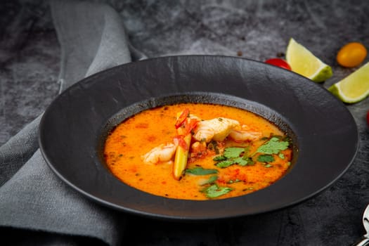 tom yam soup with chicken, lime, cherry tomatoes and parsley