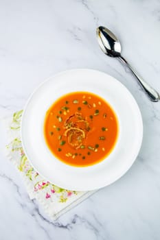 side view of pumpkin cream soup with pieces of meat