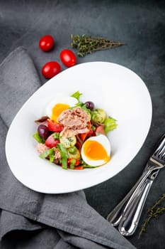 salad with soft-boiled egg, tuna, green onions, boiled potatoes