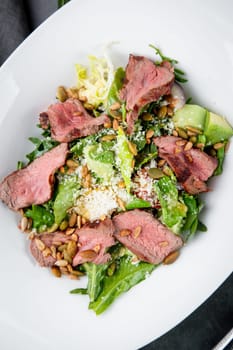 salad with pieces of beef, pistachios, lettuce and cheese. High quality photo