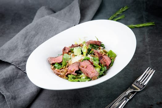 salad with pieces of beef, pistachios, lettuce and cheese. High quality photo