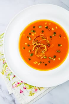 side view of pumpkin cream soup with pieces of meat