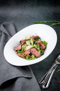 salad with pieces of beef, pistachios, lettuce and cheese. High quality photo