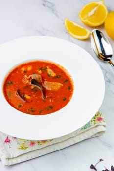 side view of pumpkin cream soup with pieces of meat