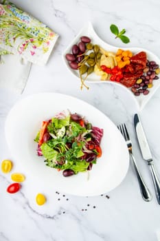 salad of greens, lettuce leaves, cucumbers, pink onions