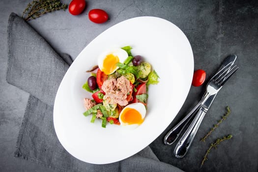 salad with soft-boiled egg, tuna, green onions, boiled potatoes