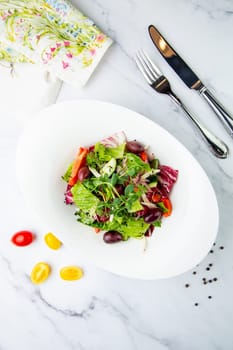 salad of greens, lettuce leaves, cucumbers, pink onions