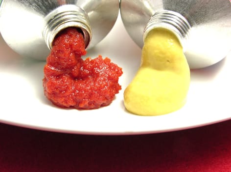 Two open tubes with tomato paste and mustard
