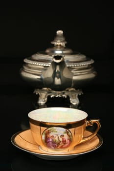 A wicker scoop with herb tea leaves and a cup of tea