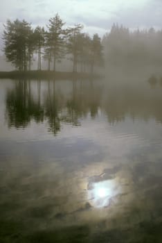 Mountain lake in the fog