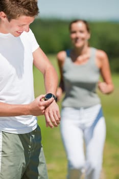 Young man with stopwatch measuring time