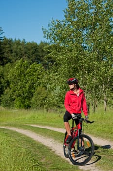 Summer - young woman ride mountain bike in nature