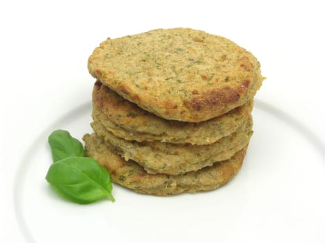 Potato patties stacked with basil