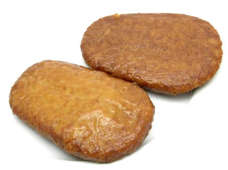 Two breaded tofu cutlets on white plate