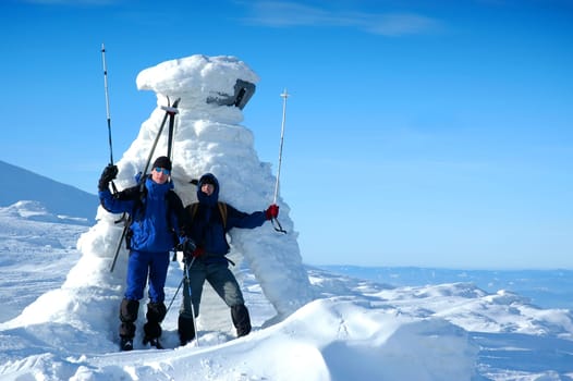 Jubilant skiers on top of mountain