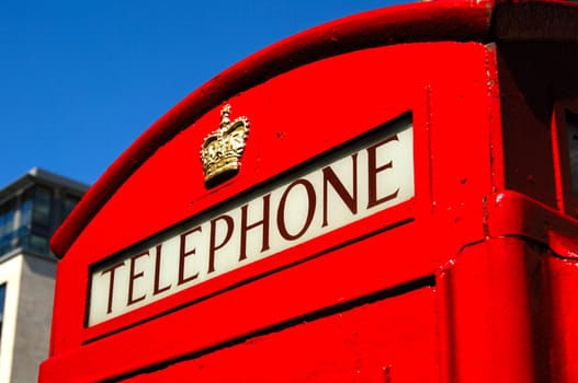 Traditional red telephone booth with the crown of St. George in central London