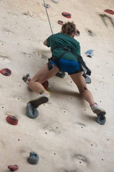 Teen rock climbing