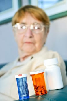 Elderly woman with pill bottles