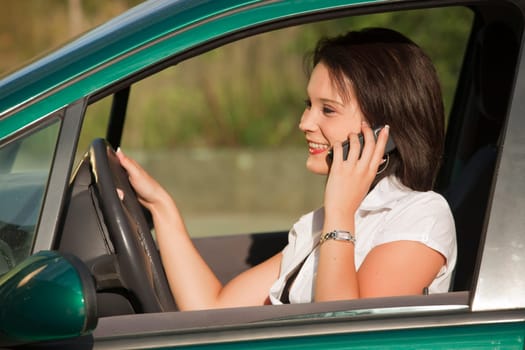Woman talking on the phone and driving car