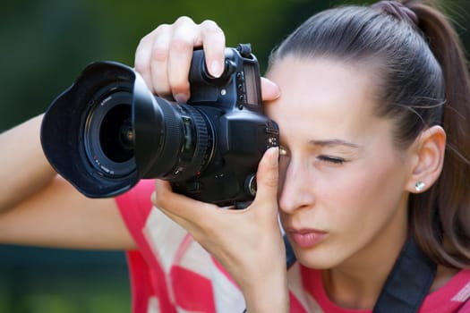 Woman taking pictures in the park