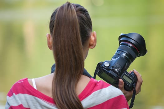 Woman with photo camera in park