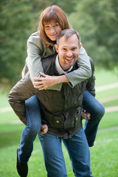 Man carrying woman on his back