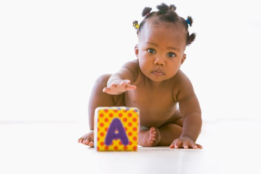 Baby playing with block