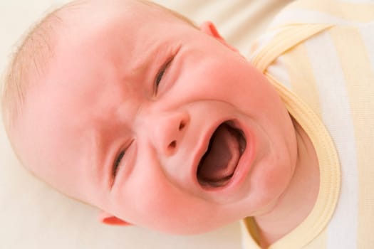Baby lying indoors crying