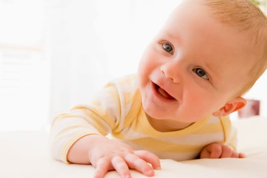 Baby lying on bed