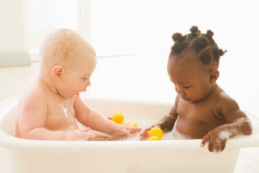 Two babies in bubble bath