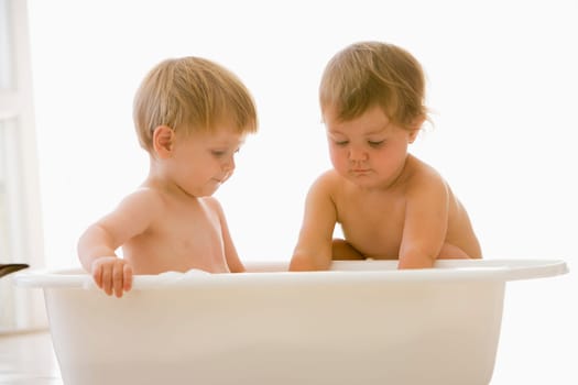 Two babies in bubble bath