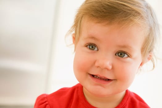Baby indoors smiling