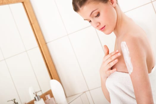 Body care series - Young lady applying lotion