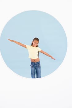 Young girl standing with arms out smiling