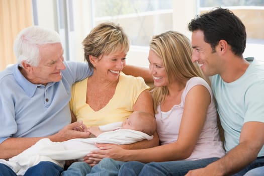 Family in living room with baby smiling