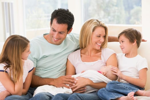 Family in living room with baby smiling