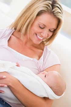 Mother in living room with baby smiling