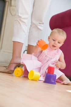 Mother in living room with baby playing