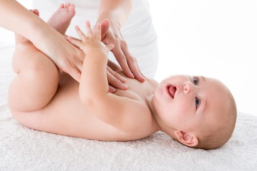 Mother massaging baby