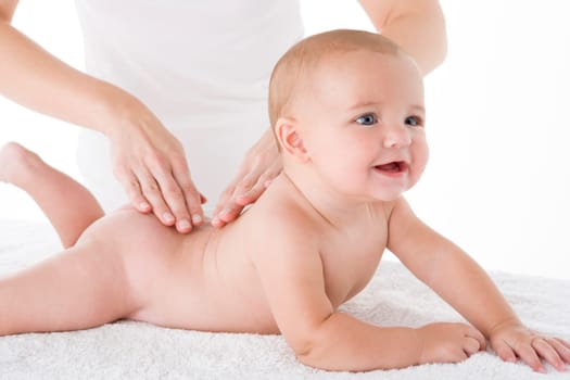 Mother massaging baby