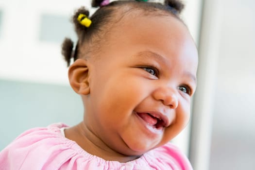 Baby indoors laughing