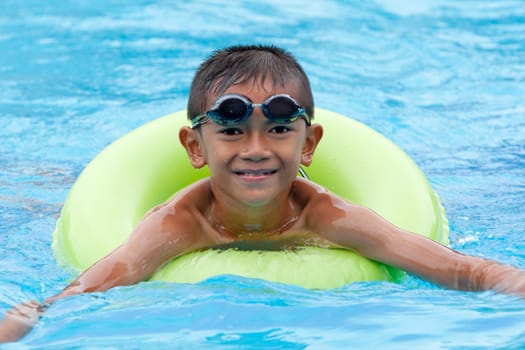 Child with swimming ring in the water