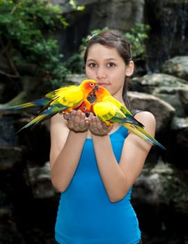 Female teenager with parakeet