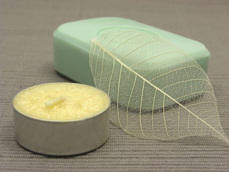 Green soap with decorative items against gray background