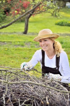 Young woman cleaning tree limbs