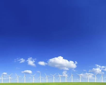 Windmills on a green hill in a sunny day