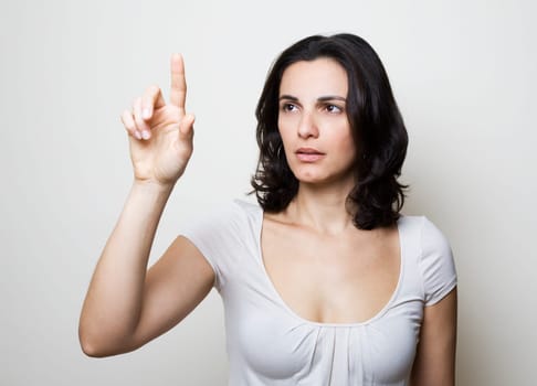 Young woman presses on a virtual